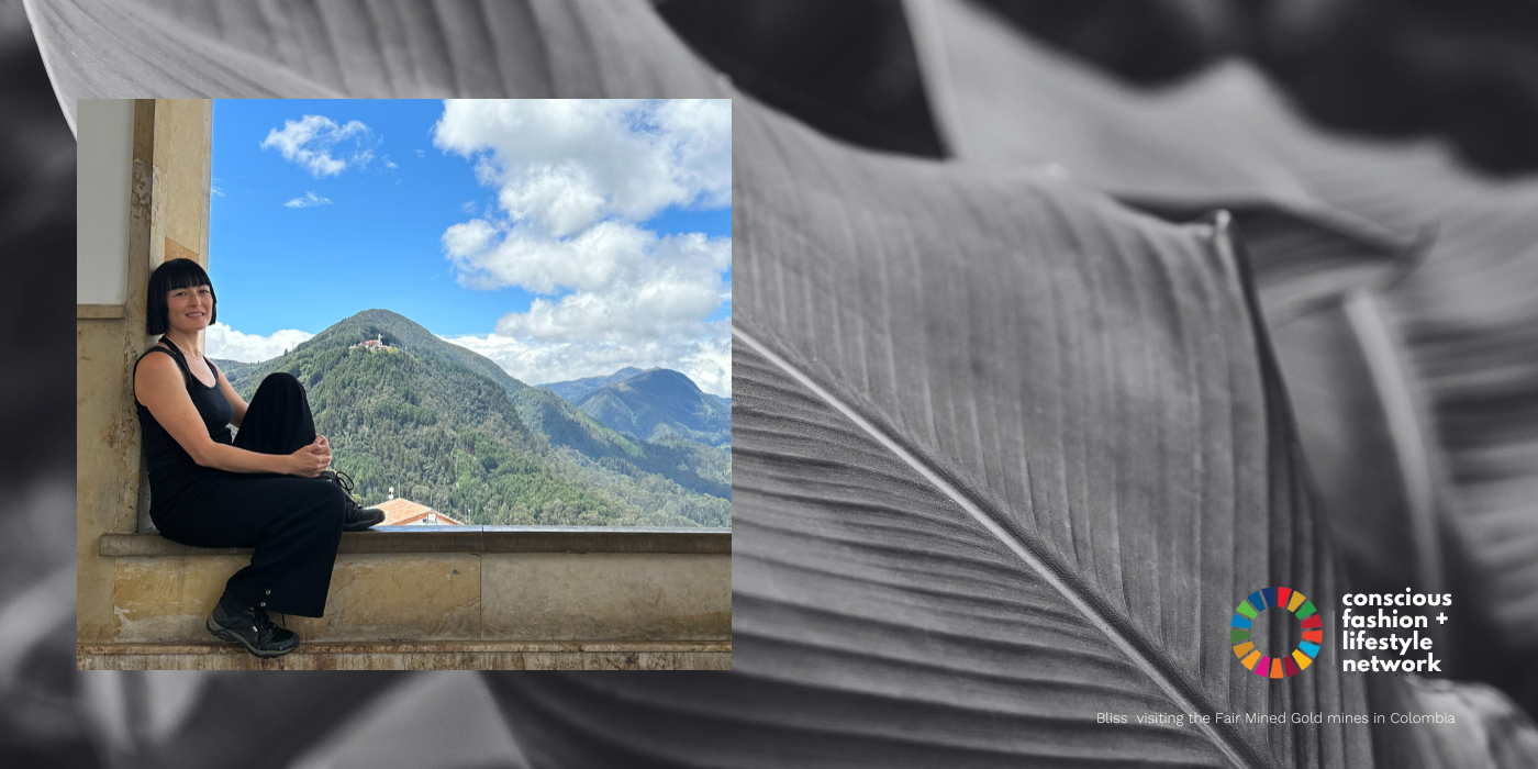 Bliss Lau sitting on a large open window ledge with a beautiful view of the mountains of Colombia when she visited the Fairmined gold mines.