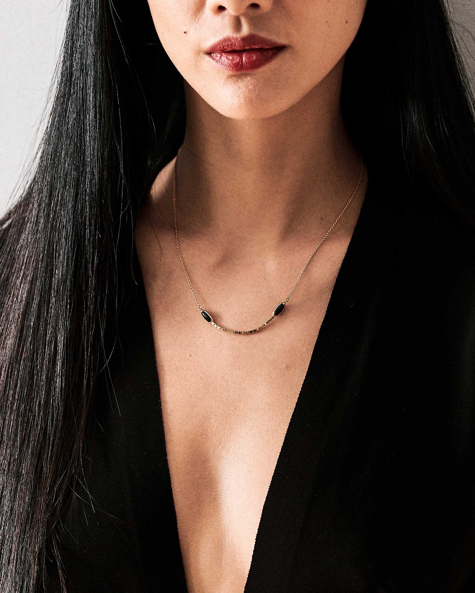 Halo Crescent Jade Necklace in 18K Gold and Black Heritage Jade – an eye-catching handcrafted jade necklace displayed elegantly, featuring black jade and gold detailing.