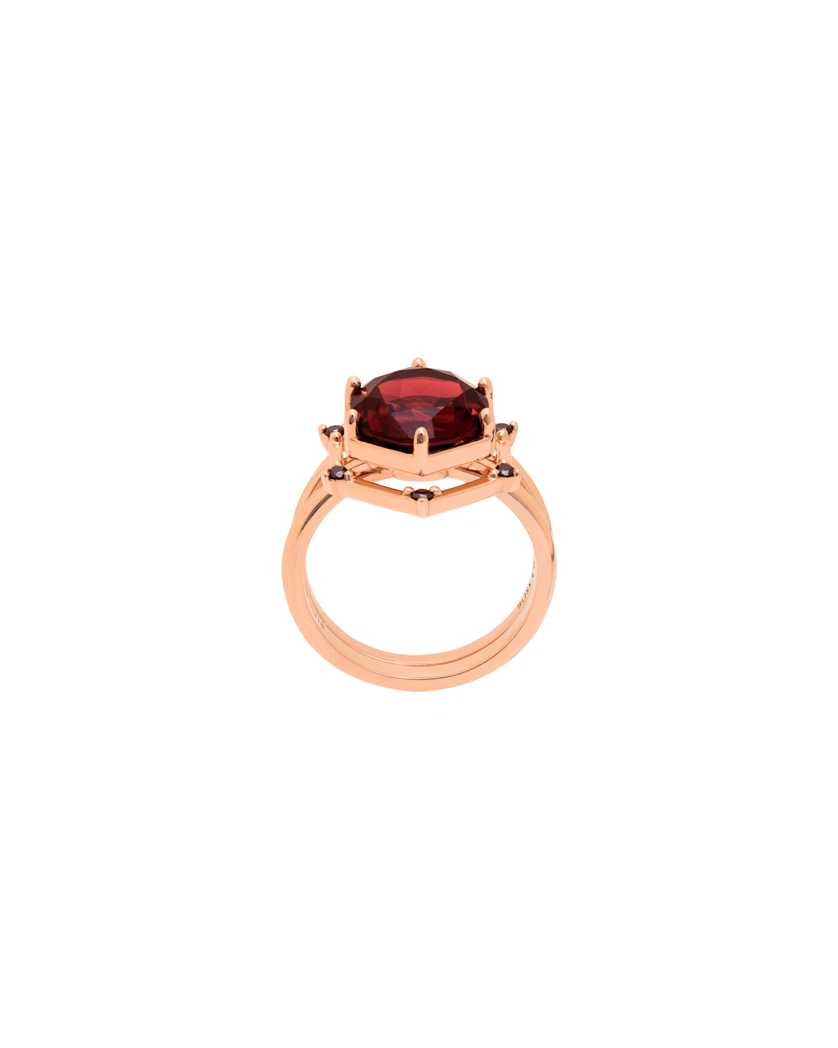 Bliss Lau interlocking ring with a red garnet center stone circled by black diamonds